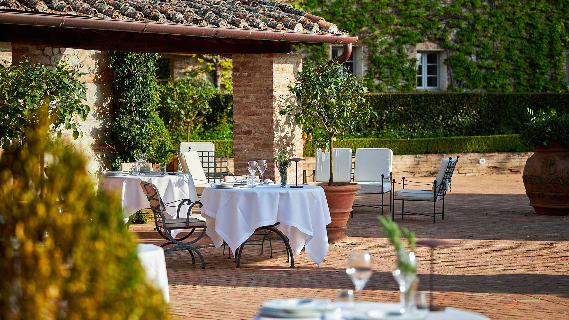 Tavolo esterno apparecchiato con tovaglia bianca, Ristorante Poggio Rosso