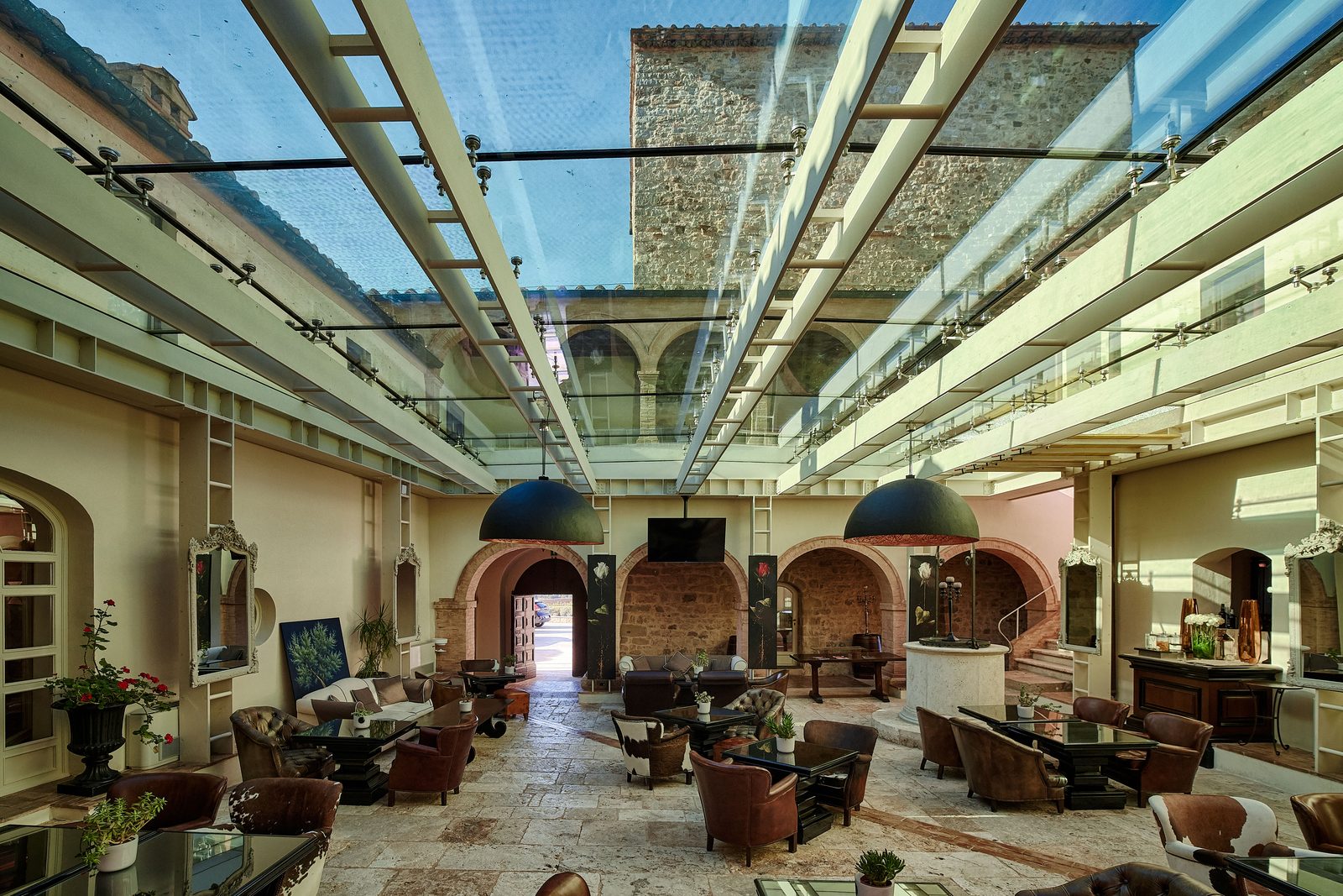 The lobby of Castello di Velona with its skylight and leather armchairs